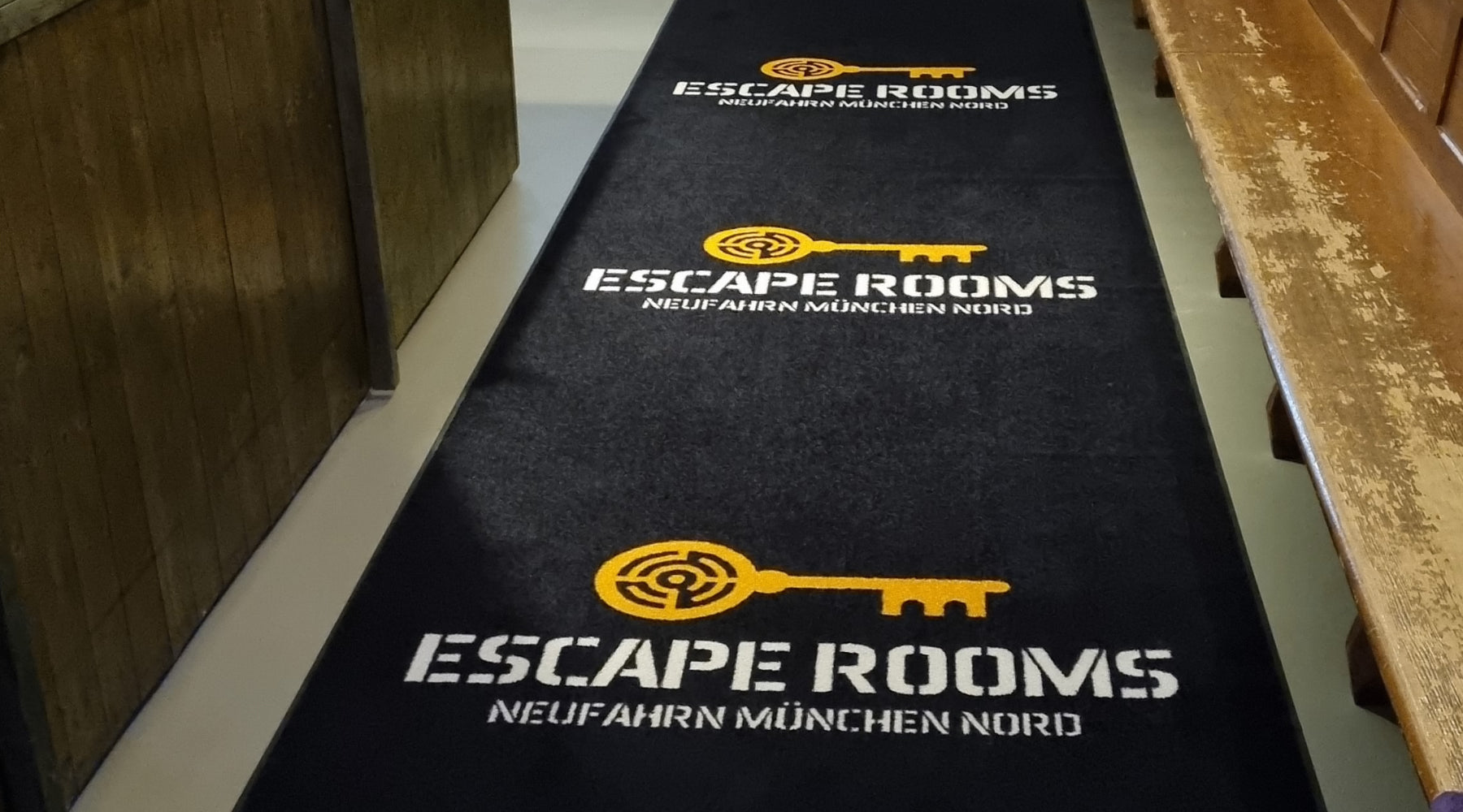 Bedruckter Teppich mit Escape Room Logo
