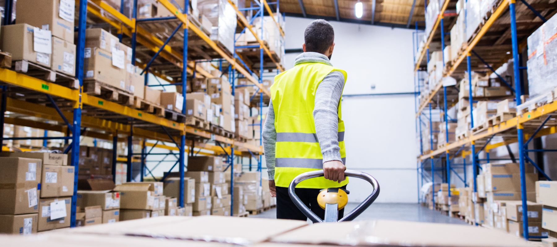 Lagermitarbeiter mit Hubwagen