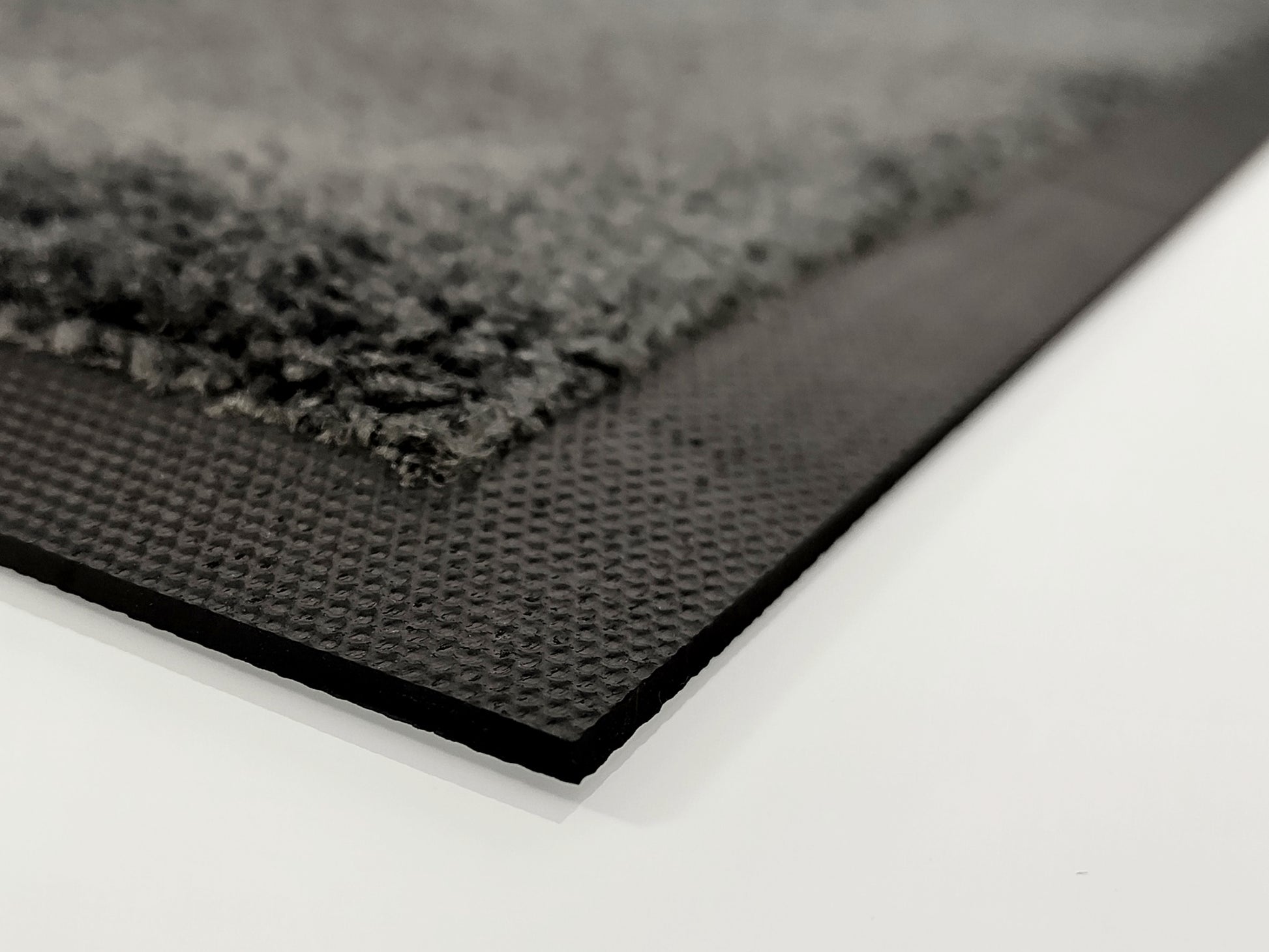 Rand einer grauen Fussmatte